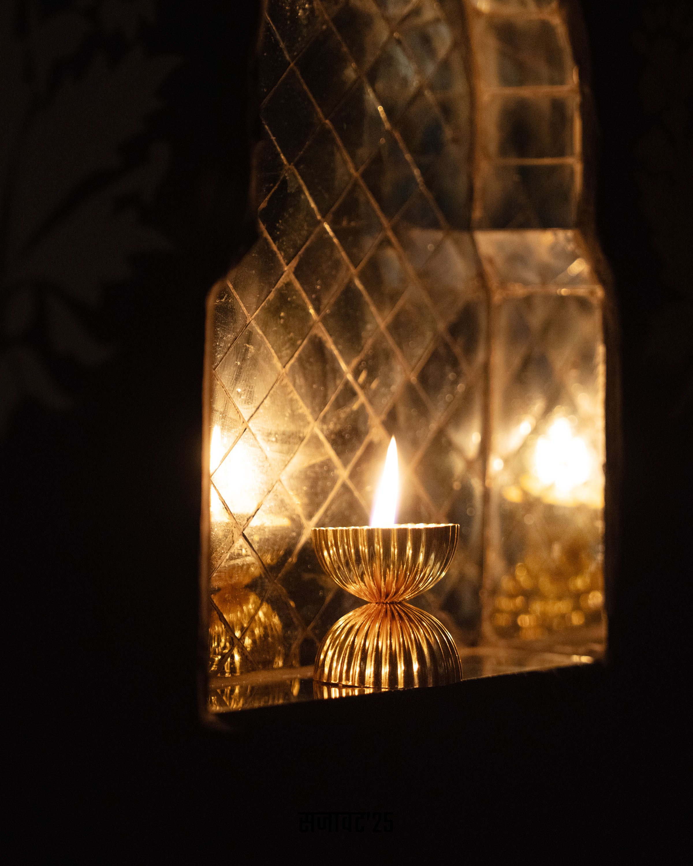Decorative wall sconce with a candle inside, featuring a textured glass cover.