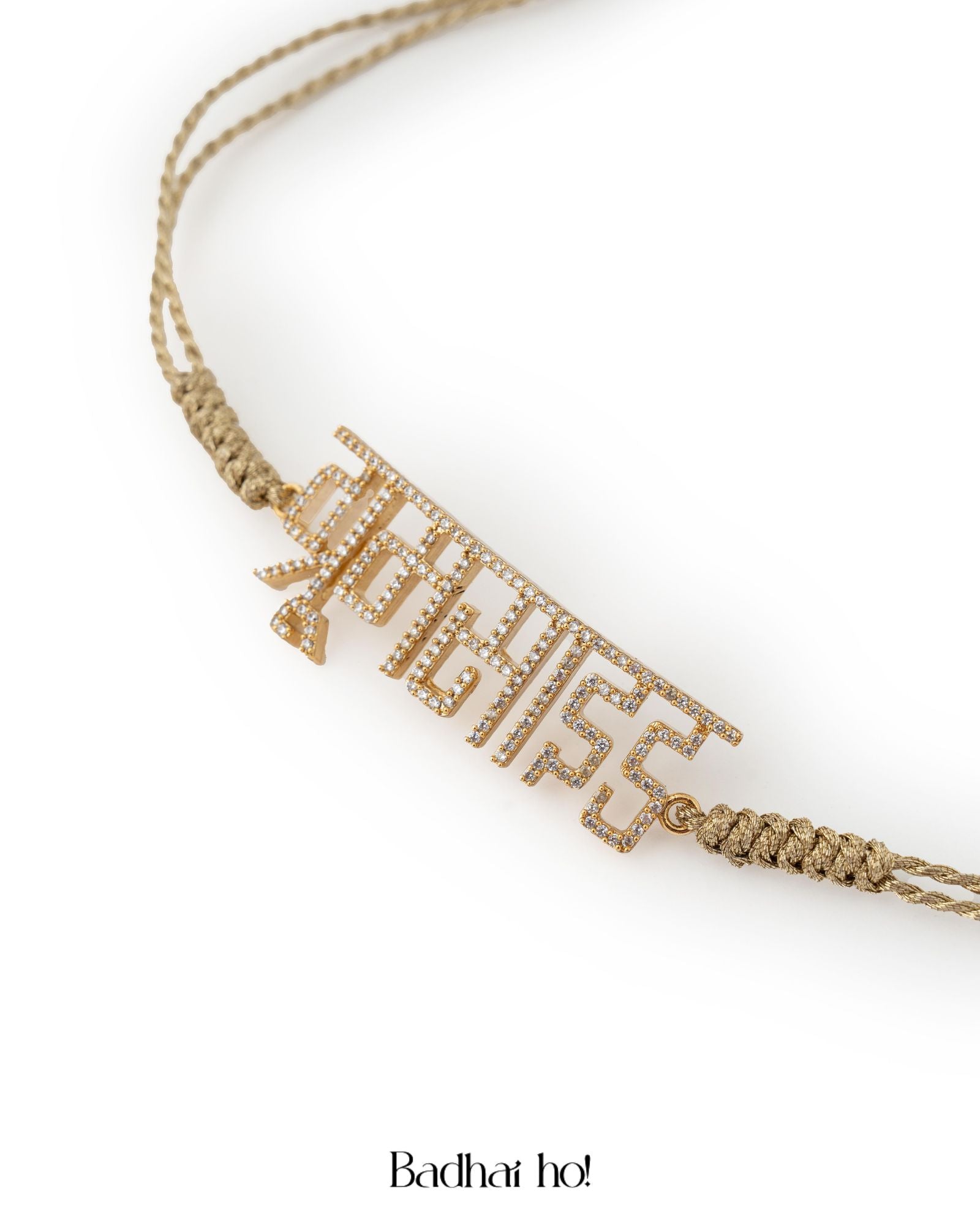 Gold bracelet with 'Badhai Ho' text on a white background