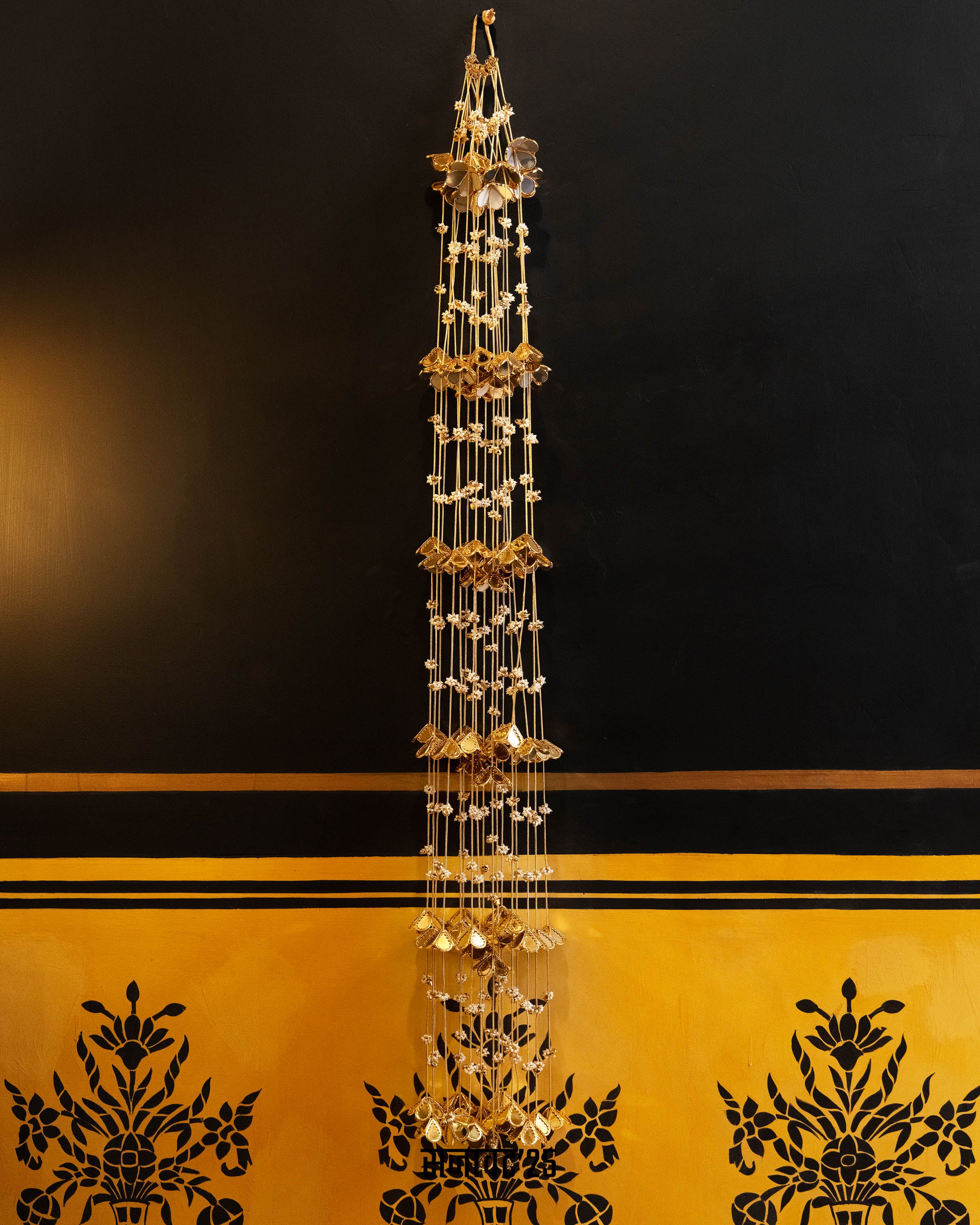 Decorative tower with gold and crystal elements on a black and yellow background