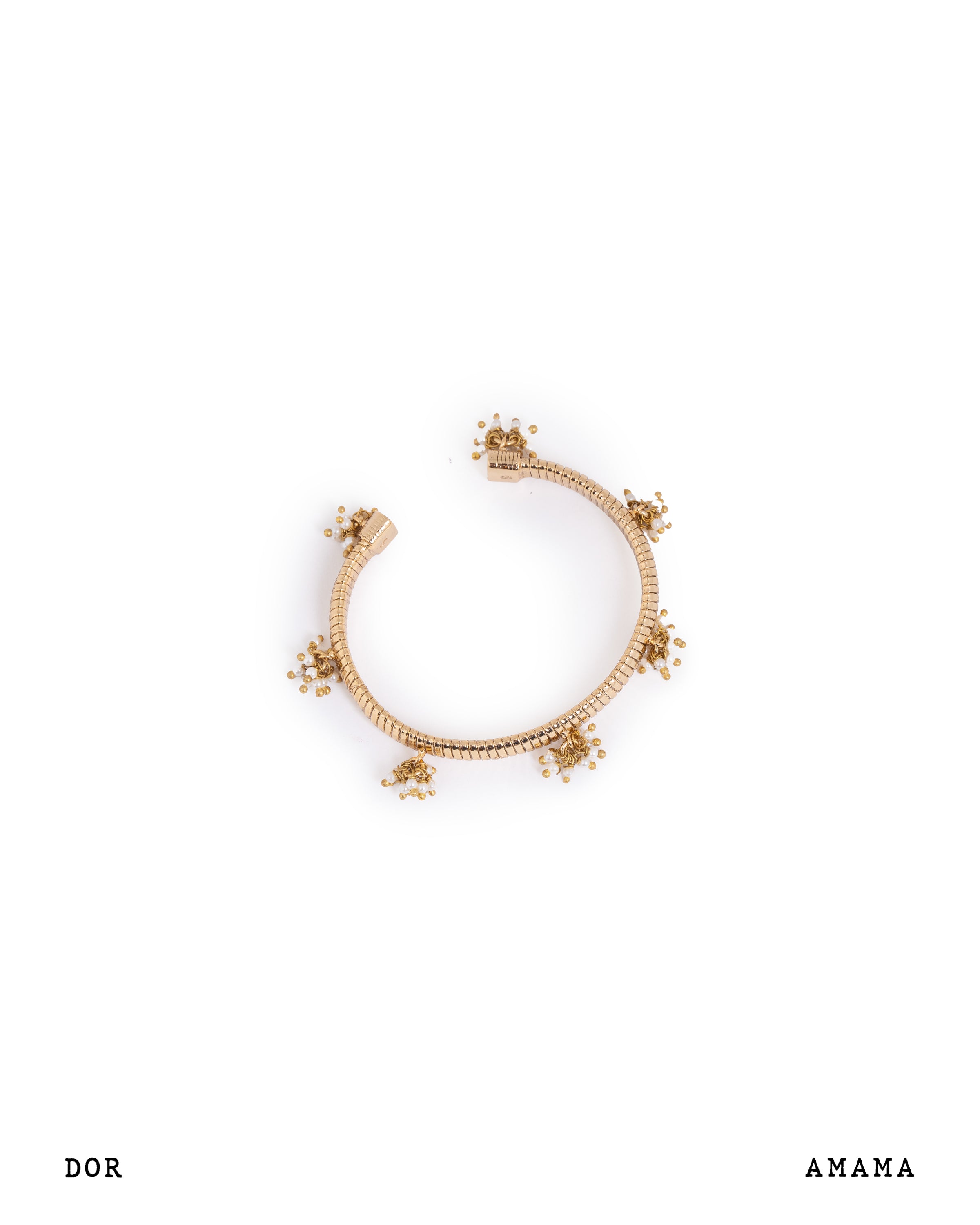 Gold bracelet with decorative elements on a white background, featuring the brand 'AMAMA'.