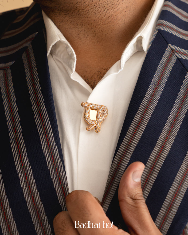 Close-up of a person wearing a striped suit with a lapel pin, brand 'Badhai Ho!' visible.