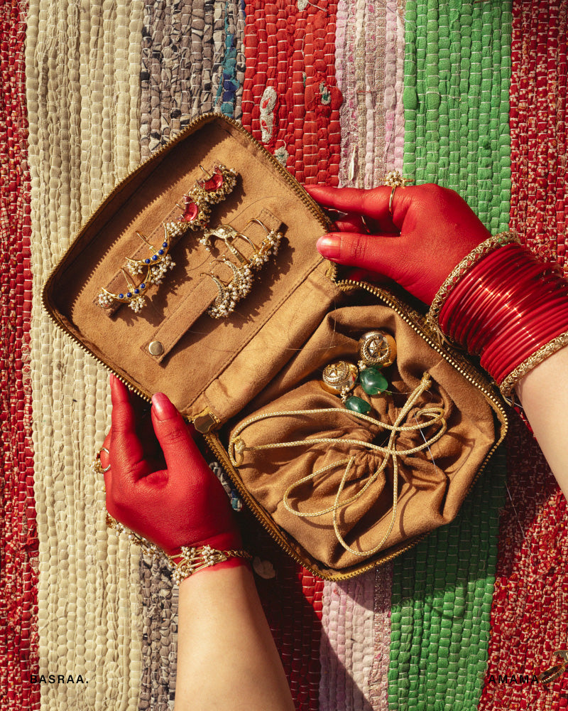 jewellery box filled with various pieces of jewelry, such as earrings and necklaces, with the box's interior visible.