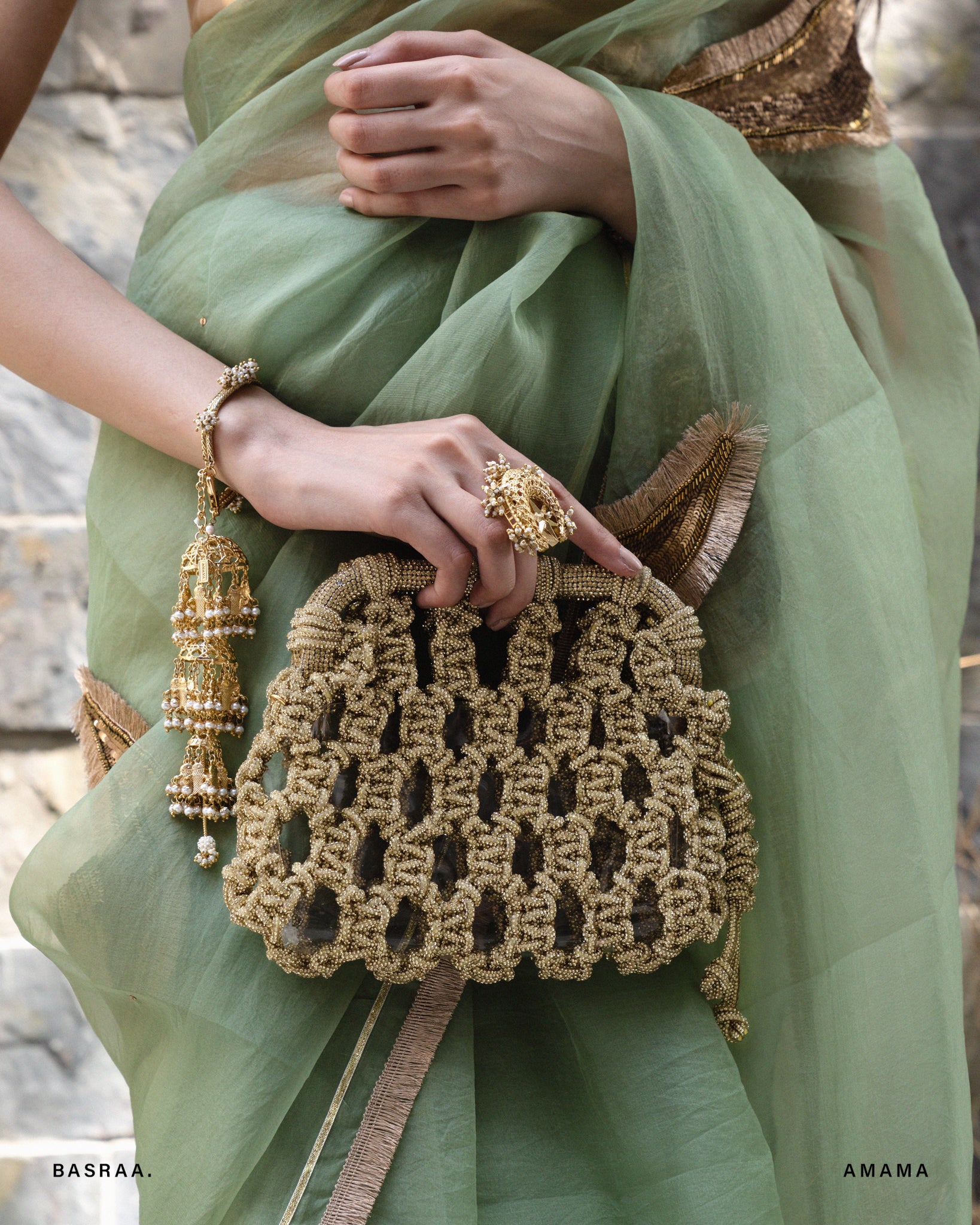 A person holding a mocha mousse colored plaided clutch purse.