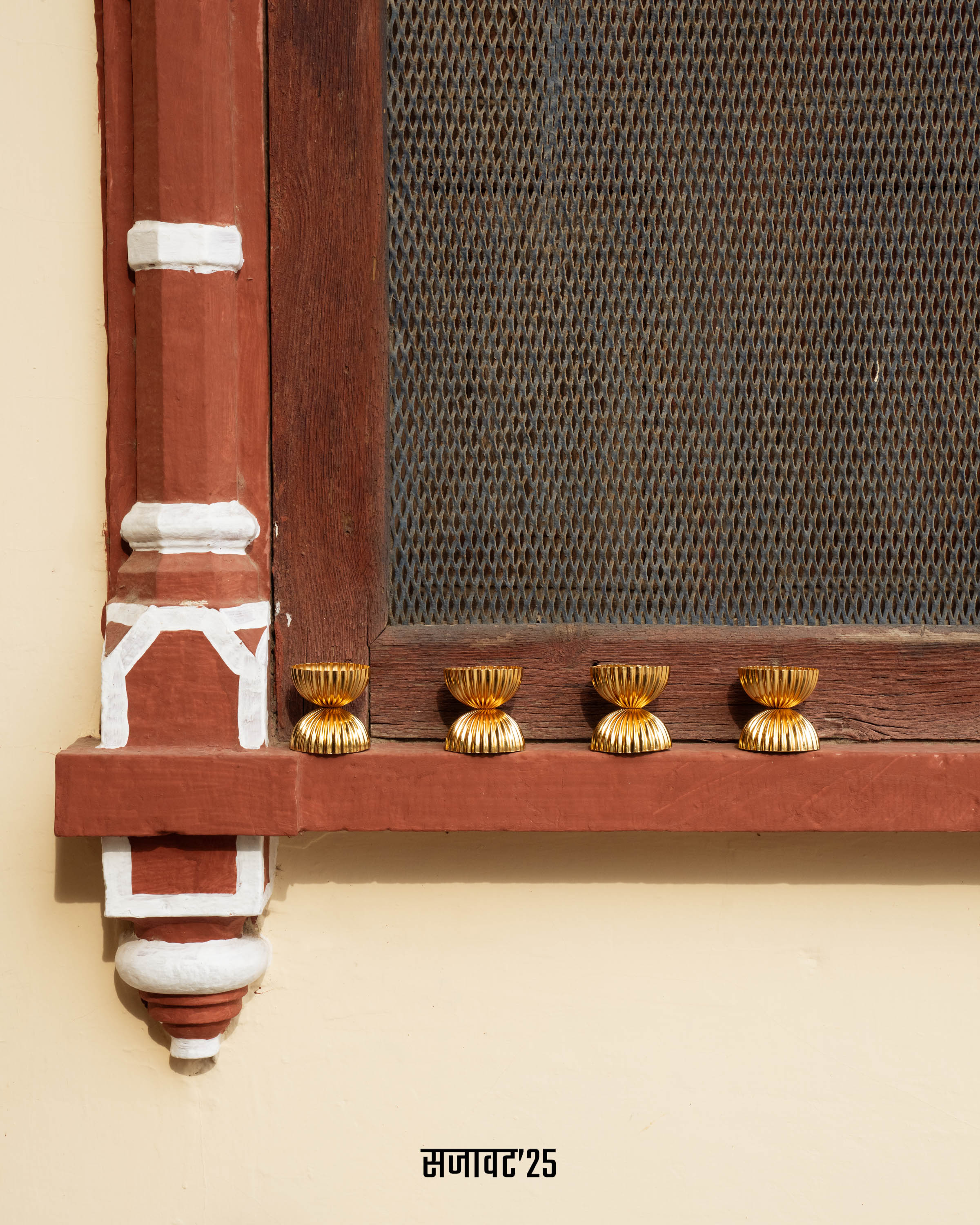 Decorative wooden shelf with gold accents on a beige wall
