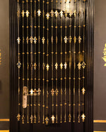 Decorative black door with gold patterns

