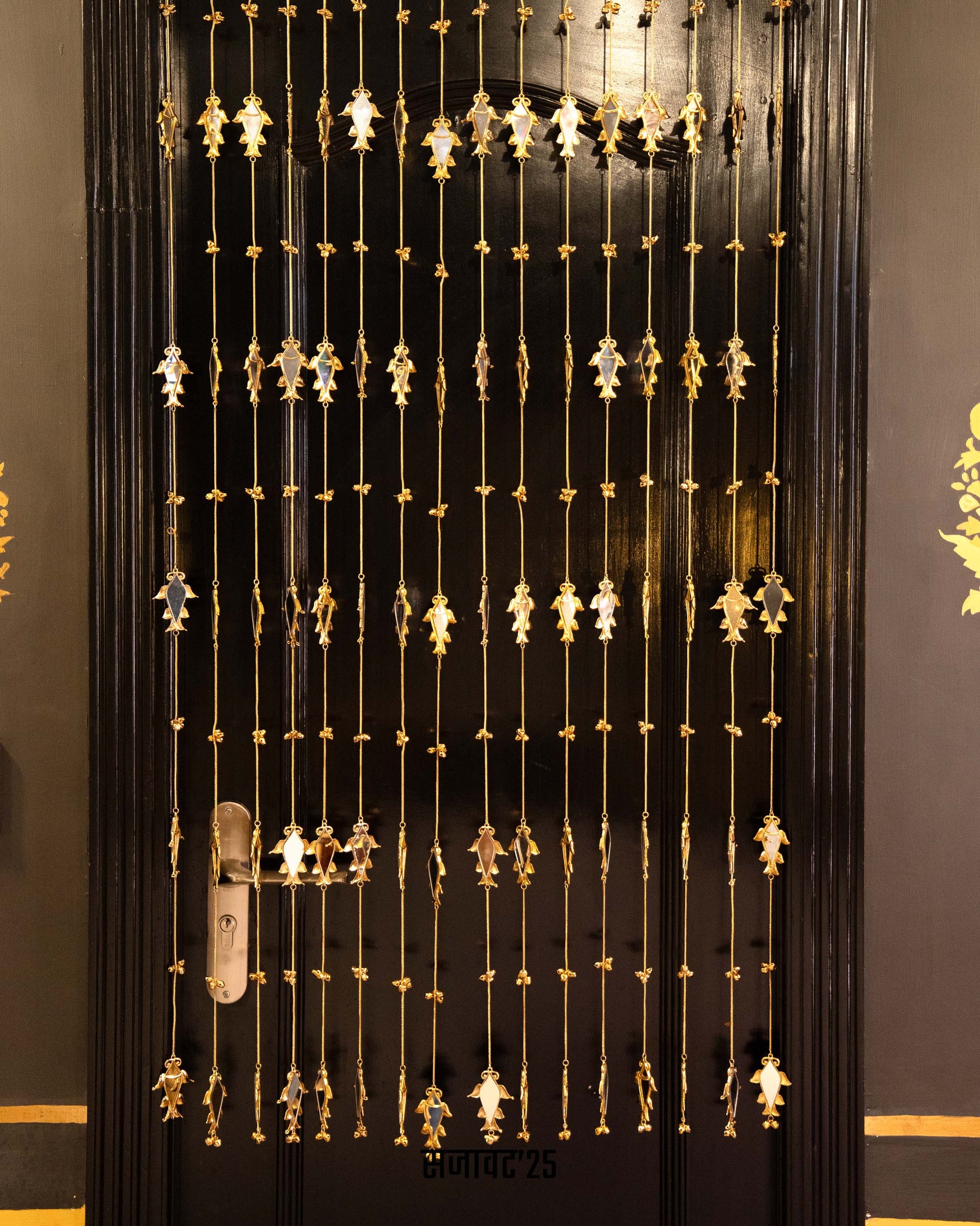 Decorative black door with gold patterns

