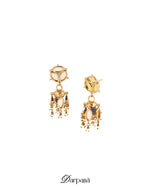 Gold earrings with gemstones on a white background, featuring the brand 'Darpana'.