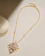 delicate chain adorned with a petite Polki pendant and a few elegant pearls