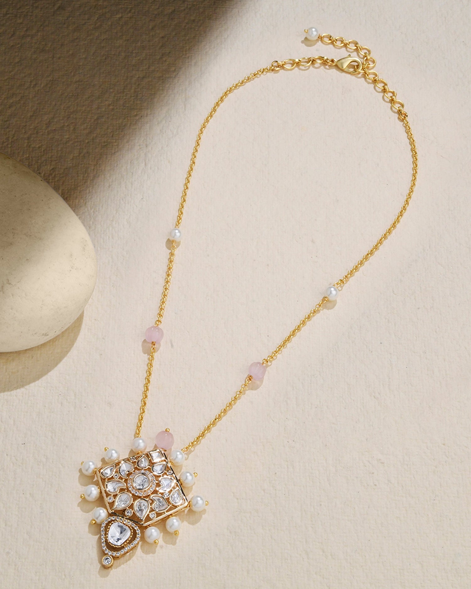 delicate chain adorned with a petite Polki pendant and a few elegant pearls